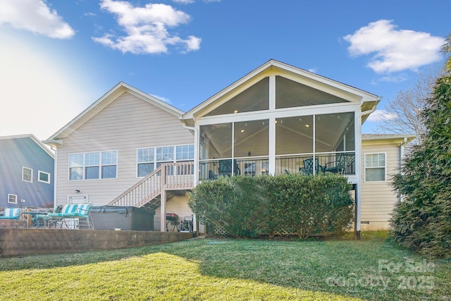 back of house featuring a patio, a hot tub, a sunroom, and a lawn