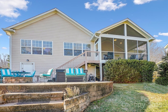 back of house featuring a yard, a patio area, a sunroom, and outdoor lounge area