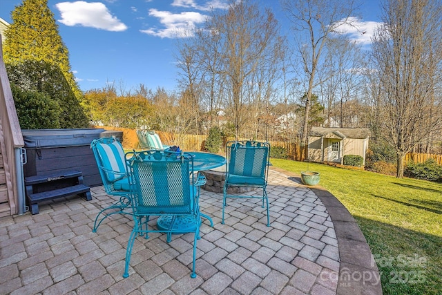 view of patio / terrace featuring a storage shed and a hot tub