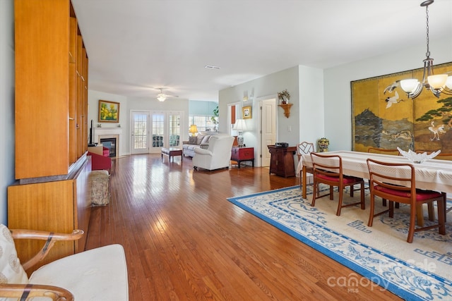 living room featuring an inviting chandelier and hardwood / wood-style floors