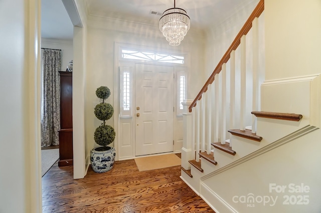 entrance foyer with crown molding and wood-type flooring