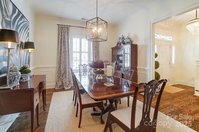 dining area featuring crown molding and a chandelier