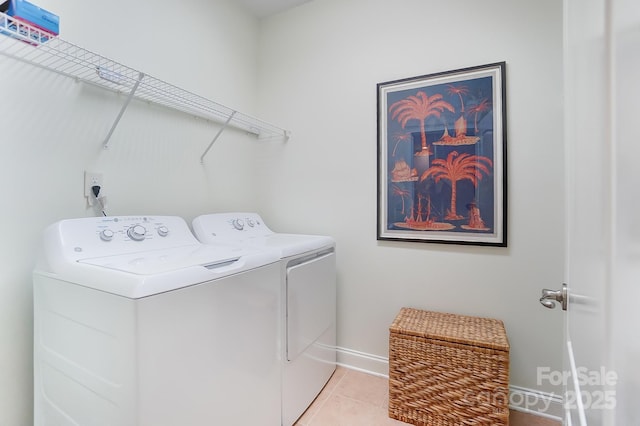 laundry room with light tile patterned flooring and washer and clothes dryer