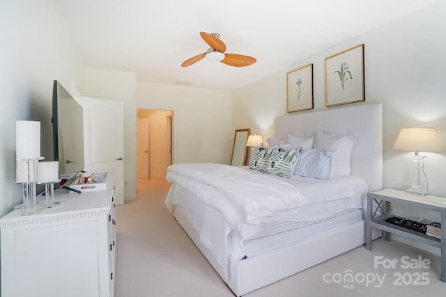 bedroom with light carpet and ceiling fan