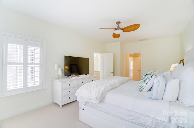 bedroom with ceiling fan and light colored carpet