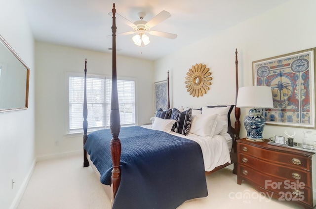 bedroom with ceiling fan and light colored carpet