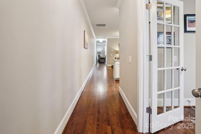 hall featuring ornamental molding and dark hardwood / wood-style flooring