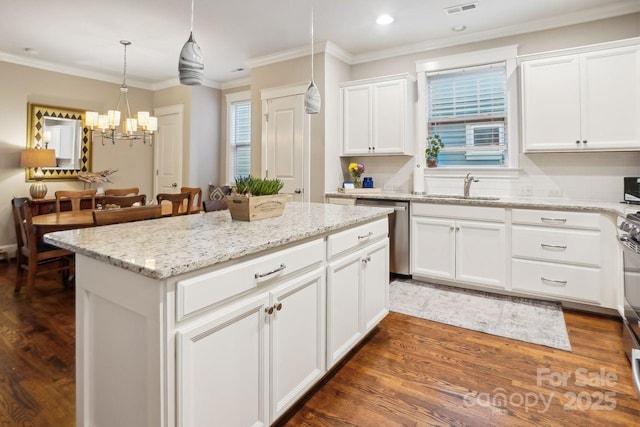 kitchen with sink, dishwasher, white cabinetry, a kitchen island, and decorative light fixtures