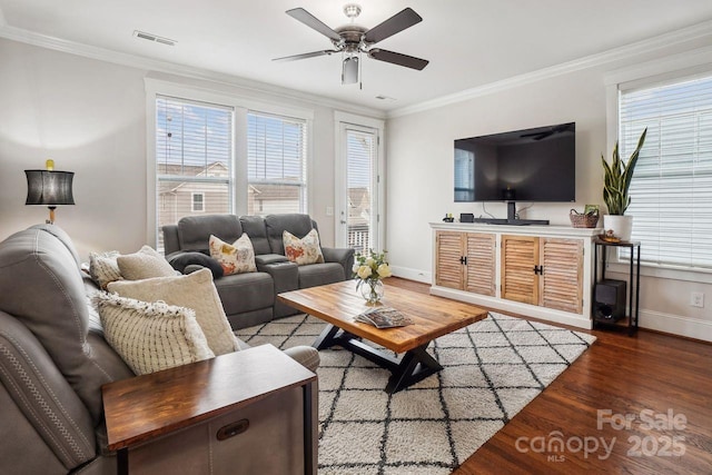 living room with hardwood / wood-style flooring, ornamental molding, and ceiling fan