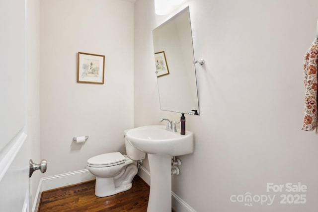 bathroom featuring sink, toilet, and hardwood / wood-style floors