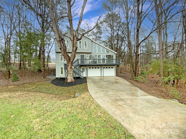 view of front of home featuring a wooden deck, a garage, and a front lawn