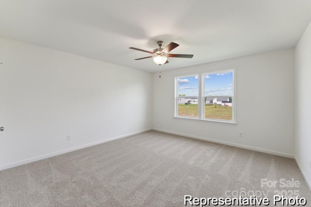 spare room featuring ceiling fan and carpet