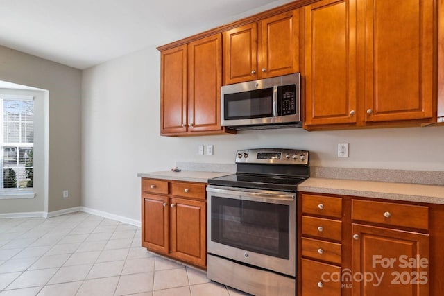 kitchen featuring appliances with stainless steel finishes and light tile patterned floors