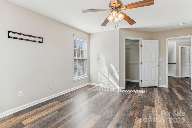 unfurnished bedroom featuring ceiling fan, dark hardwood / wood-style floors, and a closet