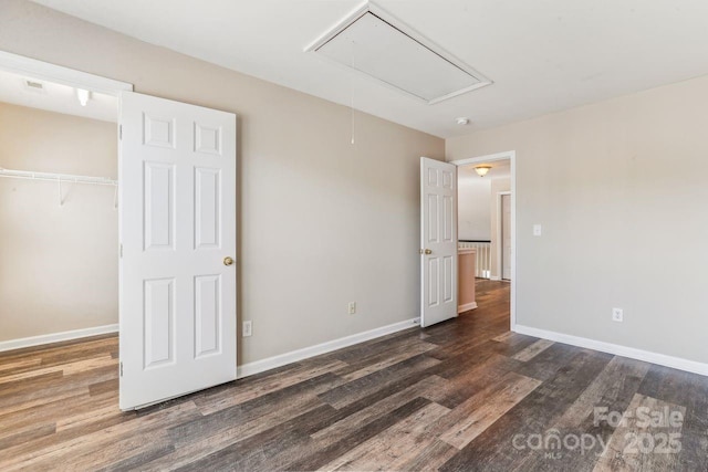 unfurnished bedroom featuring dark hardwood / wood-style flooring and a closet