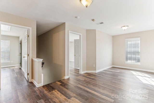 unfurnished room with dark hardwood / wood-style flooring