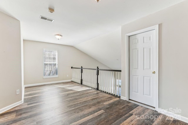 bonus room featuring hardwood / wood-style flooring and vaulted ceiling