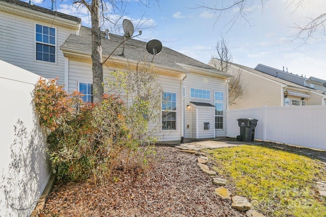 back of house with a yard and a patio area