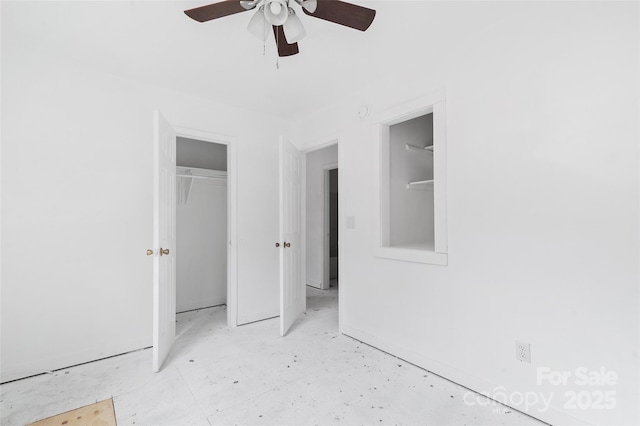 unfurnished bedroom with ceiling fan and a closet