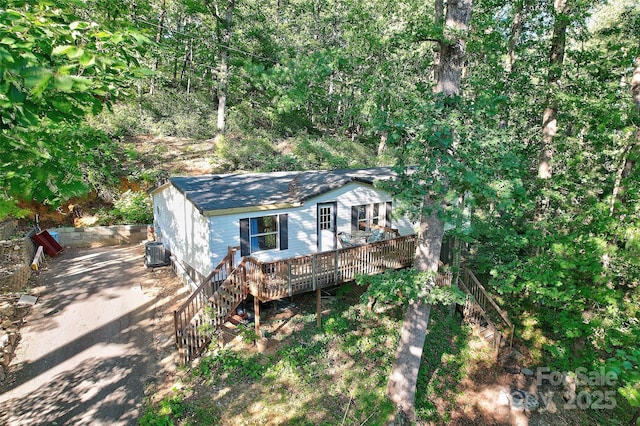 exterior space with a wooden deck and central AC unit