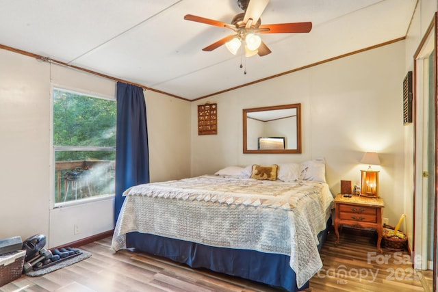 bedroom featuring hardwood / wood-style flooring, crown molding, lofted ceiling, and ceiling fan