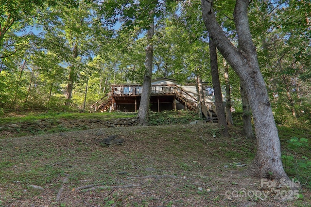 rear view of house featuring a deck