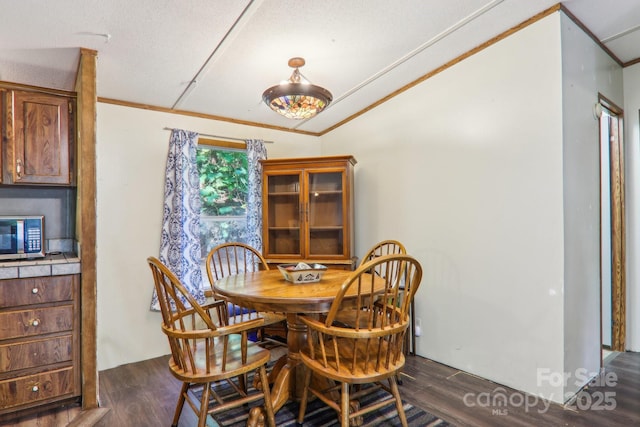 dining space with crown molding, a textured ceiling, and dark hardwood / wood-style flooring