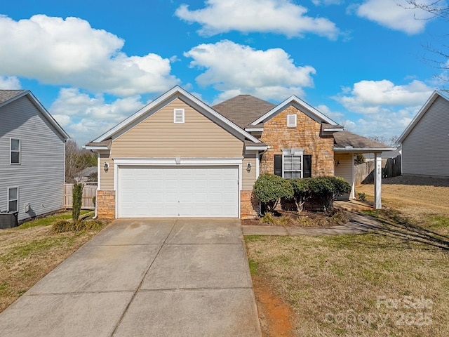 view of front of property featuring a garage and a front lawn