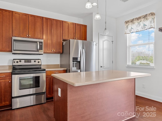 kitchen with decorative light fixtures, a kitchen island, dark hardwood / wood-style floors, and appliances with stainless steel finishes