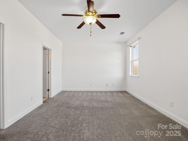 carpeted spare room with ceiling fan