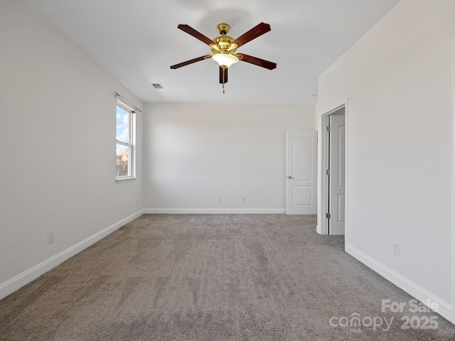 unfurnished room with ceiling fan and carpet