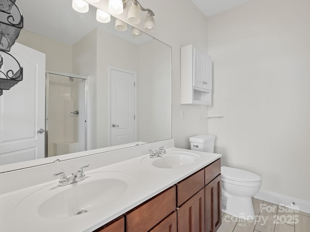 bathroom featuring walk in shower, vanity, and toilet