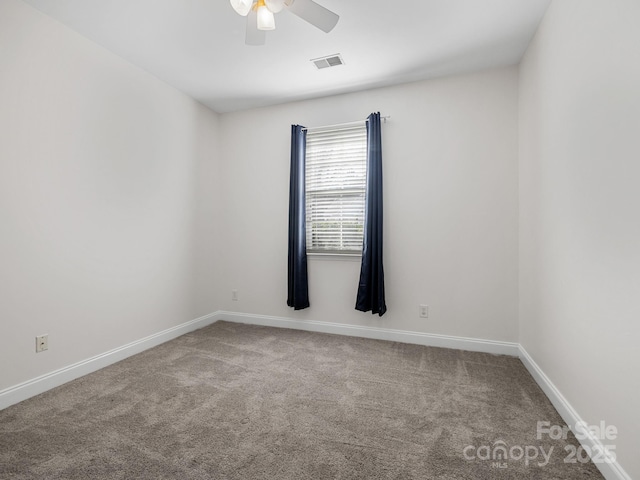 spare room with ceiling fan and carpet flooring