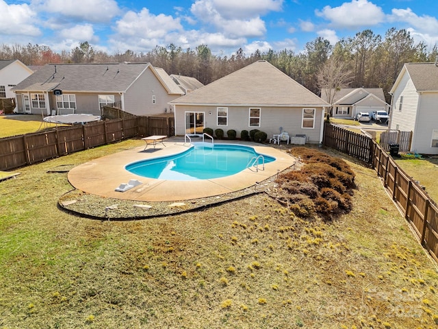 view of pool with a patio, a yard, and a diving board