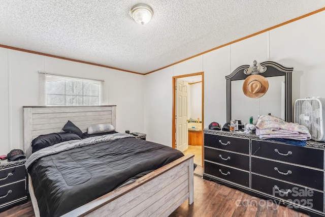 bedroom featuring connected bathroom, dark wood-style floors, ornamental molding, vaulted ceiling, and a textured ceiling