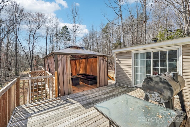 wooden deck featuring a grill and a gazebo