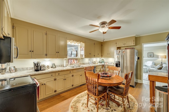 kitchen featuring sink, light wood-type flooring, ornamental molding, ceiling fan, and stainless steel appliances