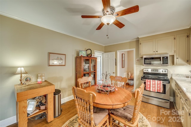 dining space with light hardwood / wood-style flooring, ornamental molding, and ceiling fan