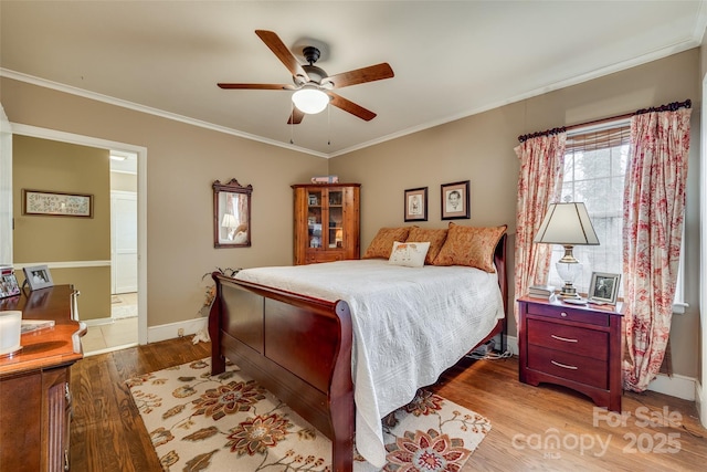 bedroom featuring crown molding, ceiling fan, and wood-type flooring