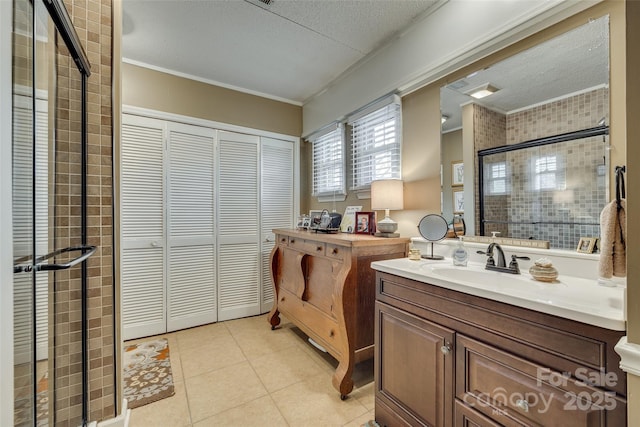 bathroom featuring an enclosed shower, ornamental molding, tile patterned floors, and vanity