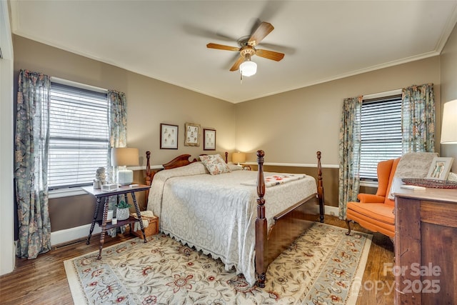 bedroom with ornamental molding, ceiling fan, and light wood-type flooring