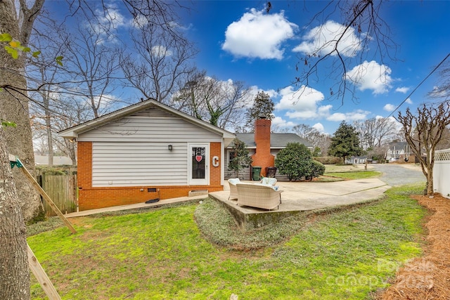 rear view of house with a yard and a patio area