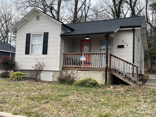 view of front of house featuring covered porch and a front lawn