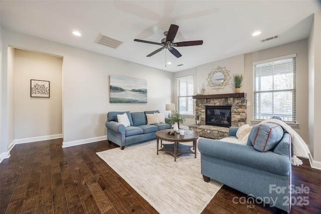 living room with ceiling fan, dark hardwood / wood-style floors, and a fireplace