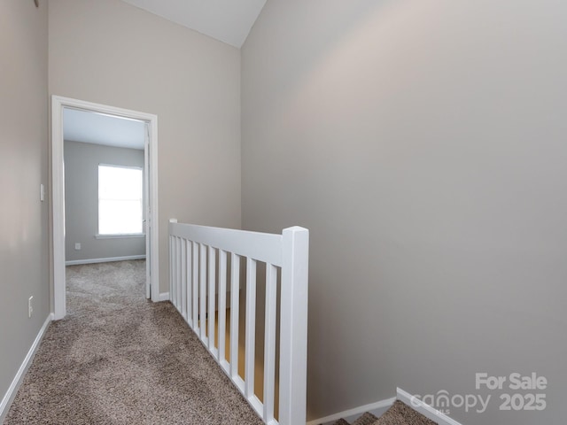 hallway with light colored carpet