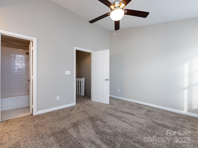 unfurnished bedroom featuring ceiling fan, ensuite bathroom, and carpet floors