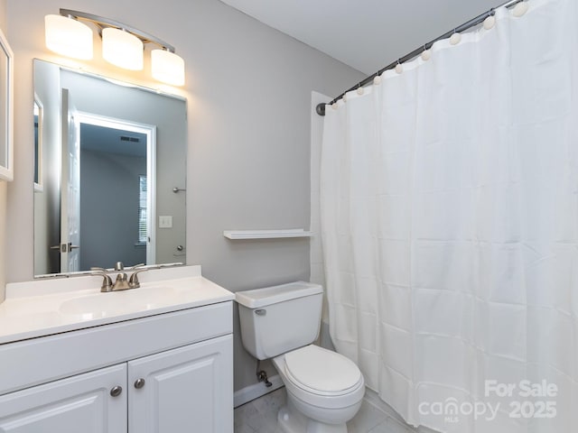 bathroom with vanity, walk in shower, and toilet