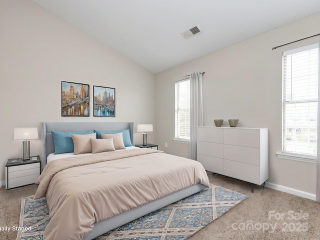 bedroom with carpet floors and vaulted ceiling