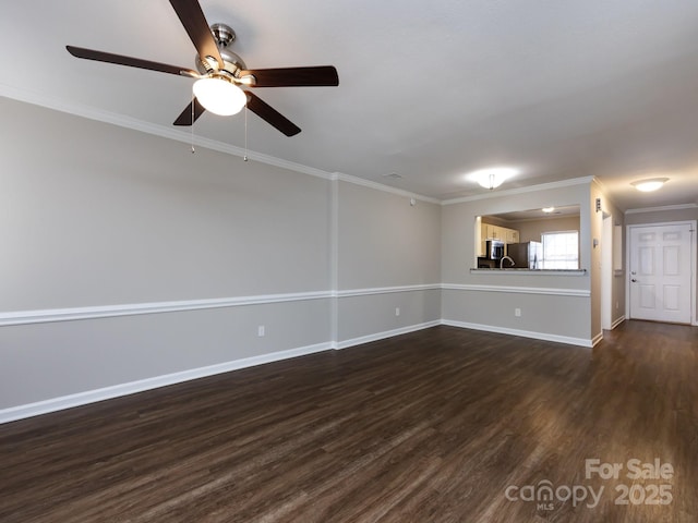 empty room with crown molding and dark wood-type flooring