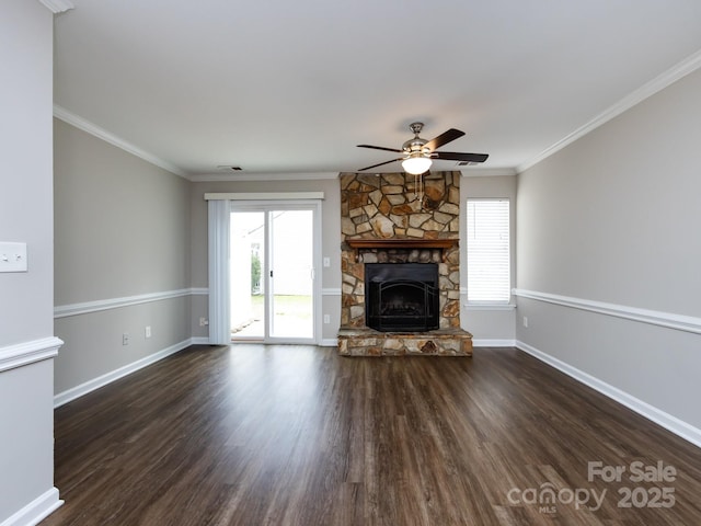 unfurnished living room featuring a stone fireplace, a wealth of natural light, and dark wood-type flooring